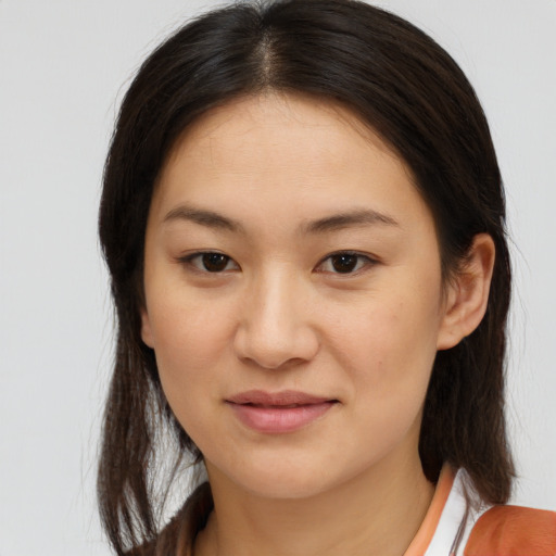 Joyful asian young-adult female with medium  brown hair and brown eyes