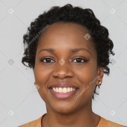 Joyful black young-adult female with short  black hair and brown eyes