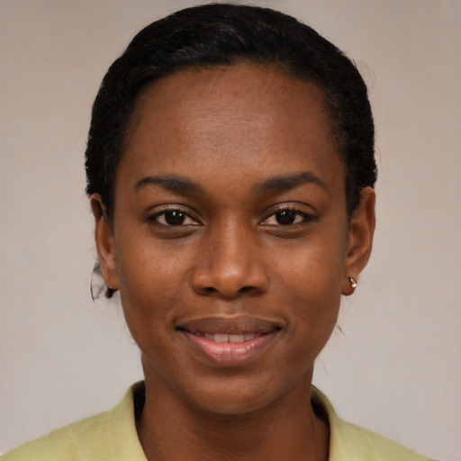 Joyful black young-adult female with short  black hair and brown eyes