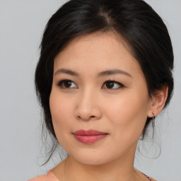 Joyful asian young-adult female with medium  brown hair and brown eyes