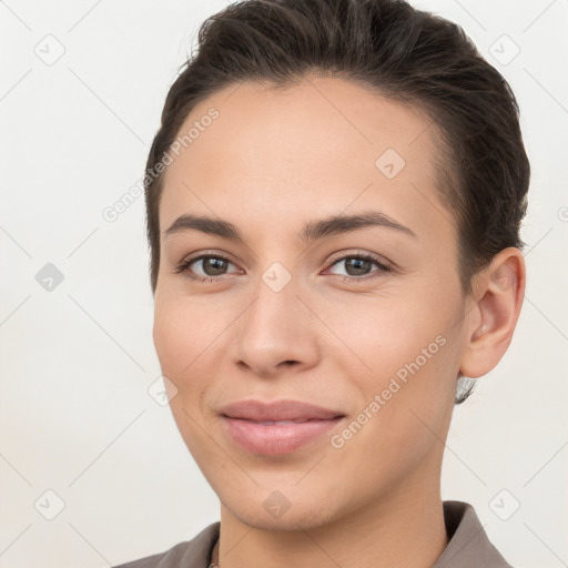 Joyful white young-adult female with short  brown hair and brown eyes