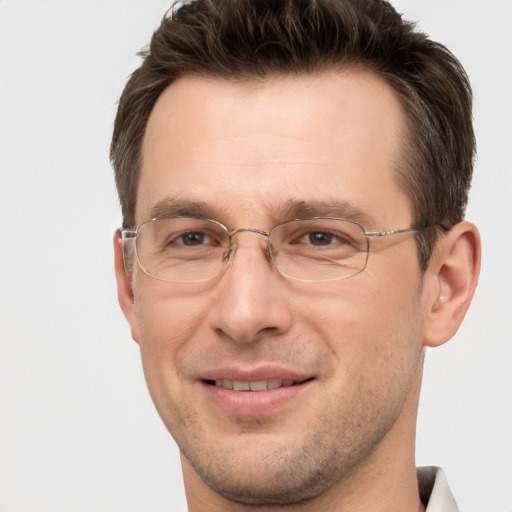 Joyful white adult male with short  brown hair and brown eyes