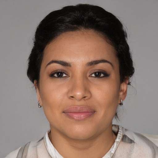 Joyful latino young-adult female with medium  brown hair and brown eyes