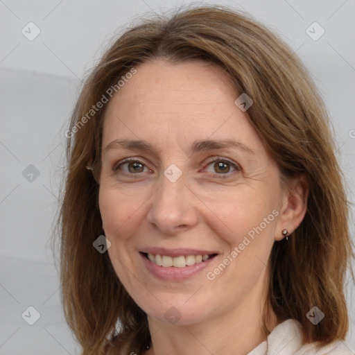 Joyful white adult female with medium  brown hair and grey eyes