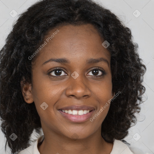 Joyful black young-adult female with long  brown hair and brown eyes