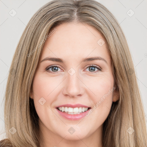 Joyful white young-adult female with long  brown hair and brown eyes