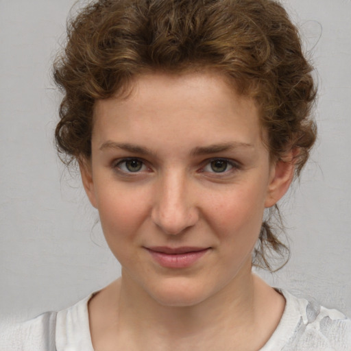 Joyful white young-adult female with medium  brown hair and blue eyes