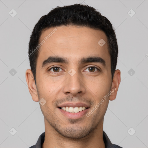 Joyful white young-adult male with short  black hair and brown eyes