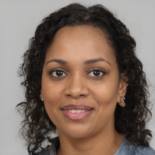 Joyful black young-adult female with medium  brown hair and brown eyes