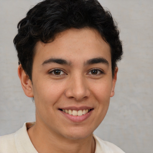 Joyful latino young-adult male with short  brown hair and brown eyes