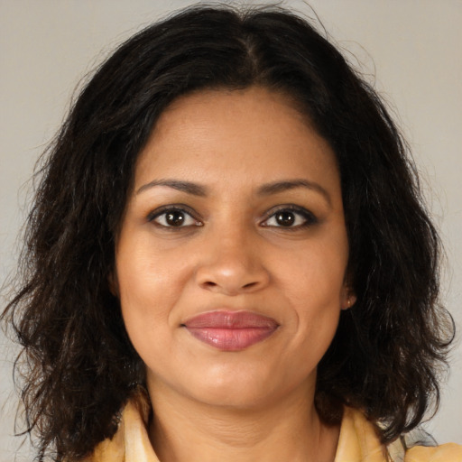 Joyful black young-adult female with medium  brown hair and brown eyes