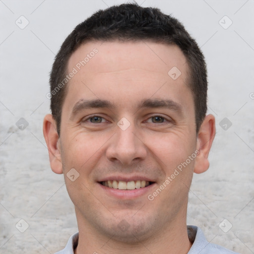 Joyful white young-adult male with short  brown hair and brown eyes