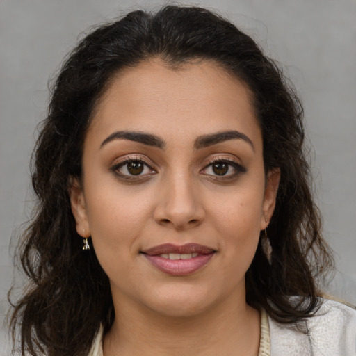 Joyful latino young-adult female with medium  brown hair and brown eyes