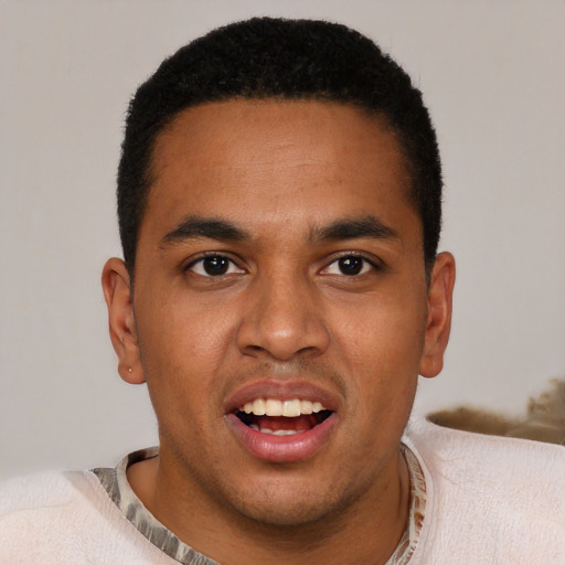 Joyful black young-adult male with short  brown hair and brown eyes