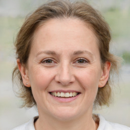 Joyful white adult female with medium  brown hair and brown eyes