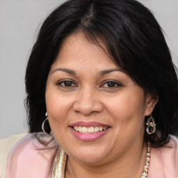 Joyful white adult female with medium  brown hair and brown eyes