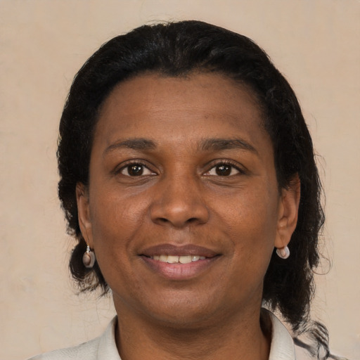 Joyful black young-adult female with medium  brown hair and brown eyes