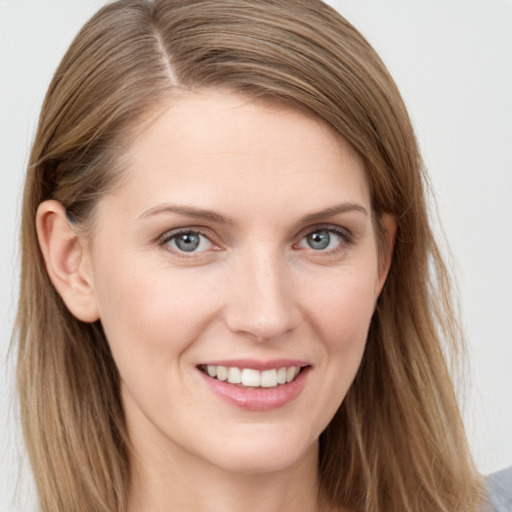 Joyful white young-adult female with long  brown hair and grey eyes