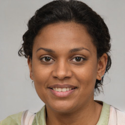 Joyful black young-adult female with medium  brown hair and brown eyes