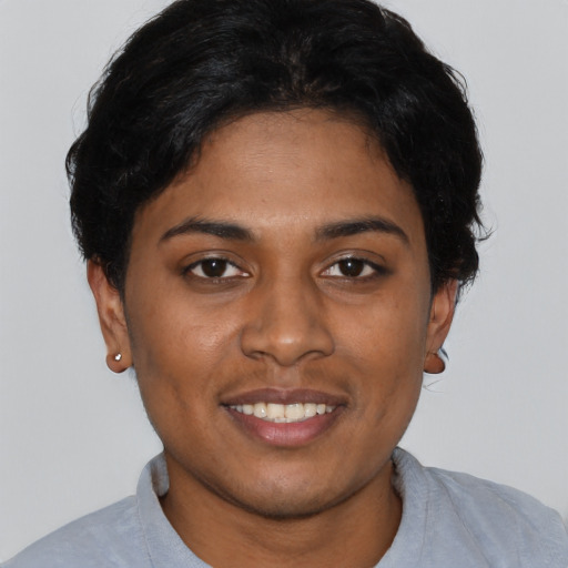 Joyful black young-adult female with short  black hair and brown eyes