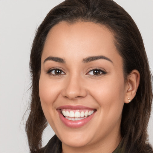 Joyful white young-adult female with long  brown hair and brown eyes