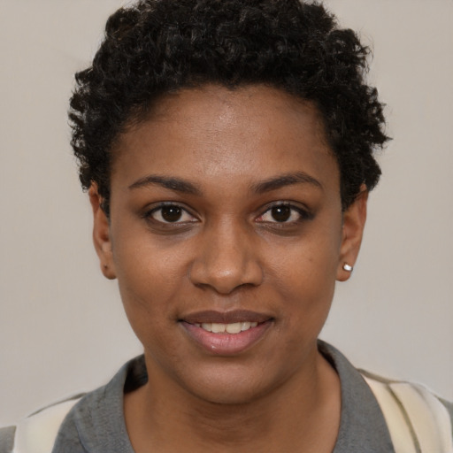 Joyful black young-adult female with short  brown hair and brown eyes