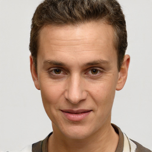 Joyful white adult male with short  brown hair and brown eyes