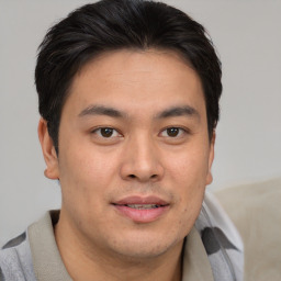 Joyful asian young-adult male with short  brown hair and brown eyes