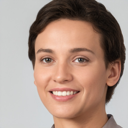 Joyful white young-adult female with short  brown hair and brown eyes