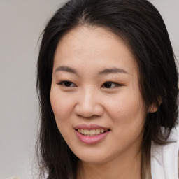 Joyful asian young-adult female with long  brown hair and brown eyes