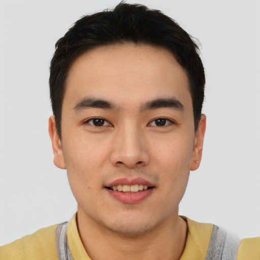 Joyful asian young-adult male with short  black hair and brown eyes