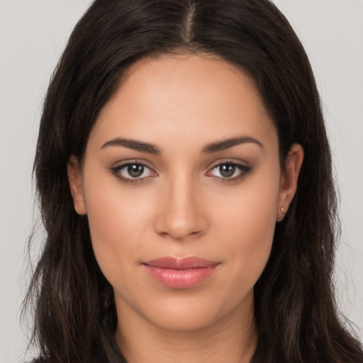 Joyful white young-adult female with long  brown hair and brown eyes