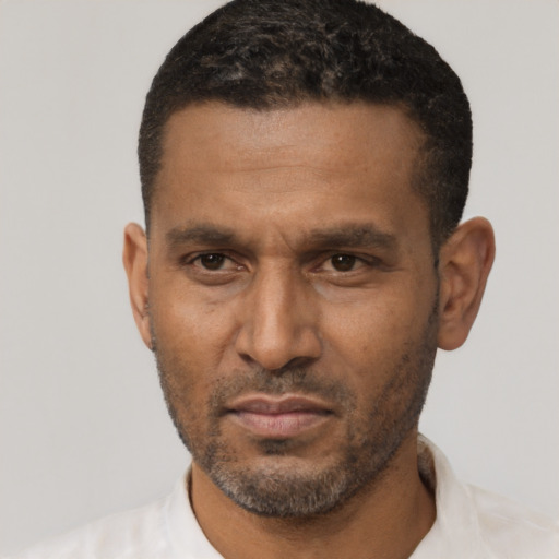 Neutral latino adult male with short  black hair and brown eyes