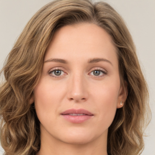 Joyful white young-adult female with long  brown hair and green eyes