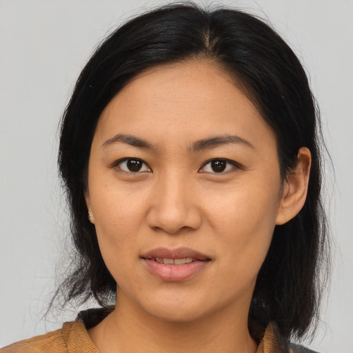 Joyful asian young-adult female with medium  brown hair and brown eyes