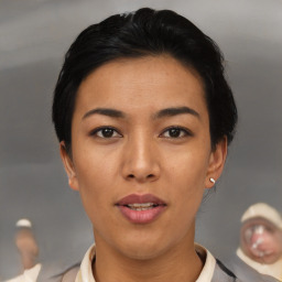 Joyful asian young-adult female with short  black hair and brown eyes