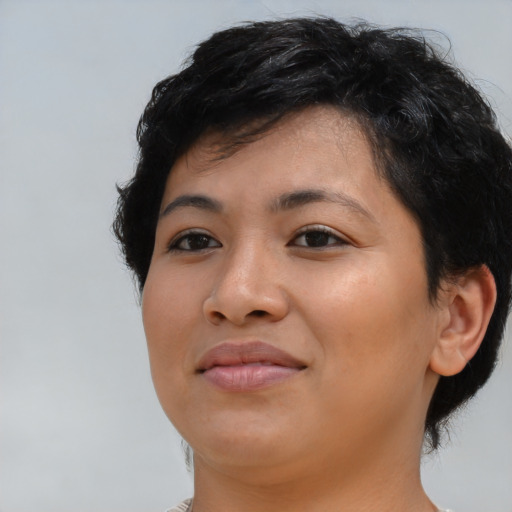 Joyful latino young-adult female with short  brown hair and brown eyes