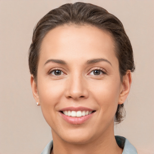 Joyful white young-adult female with short  brown hair and brown eyes