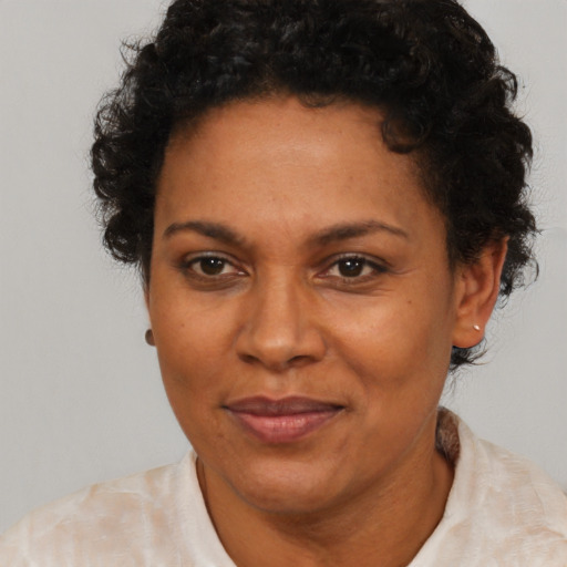 Joyful black adult female with short  brown hair and brown eyes