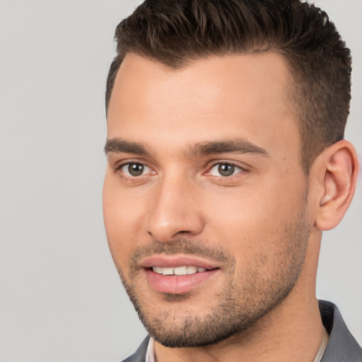 Joyful white young-adult male with short  brown hair and brown eyes