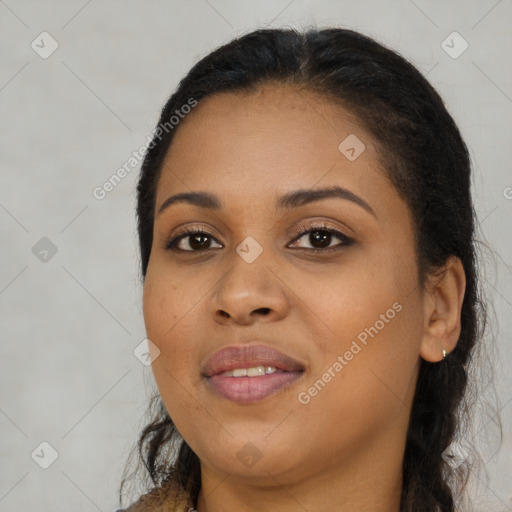 Joyful black young-adult female with long  brown hair and brown eyes