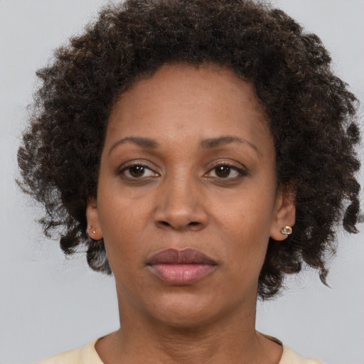 Joyful black adult female with short  brown hair and brown eyes