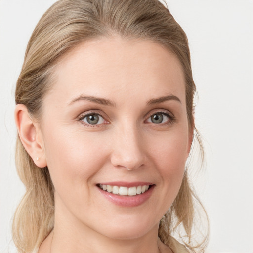 Joyful white young-adult female with long  brown hair and blue eyes