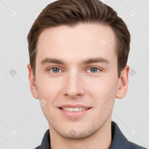 Joyful white young-adult male with short  brown hair and grey eyes