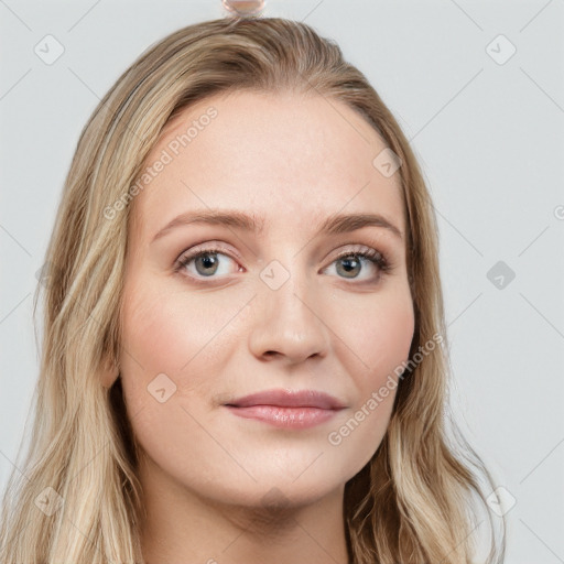 Joyful white young-adult female with long  brown hair and blue eyes