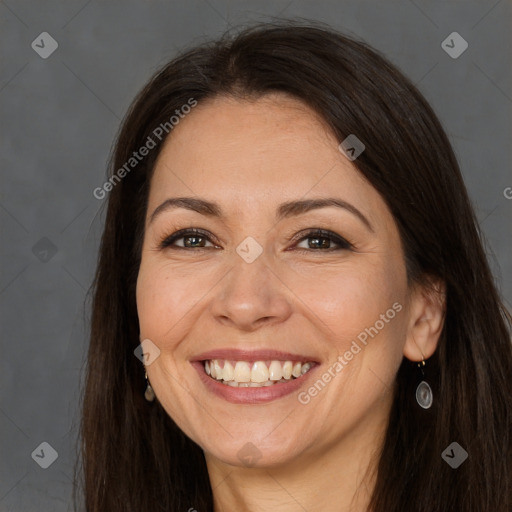 Joyful white adult female with long  brown hair and brown eyes