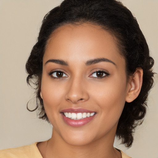 Joyful latino young-adult female with medium  brown hair and brown eyes