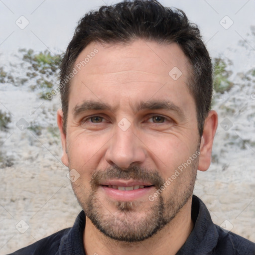 Joyful white adult male with short  brown hair and brown eyes