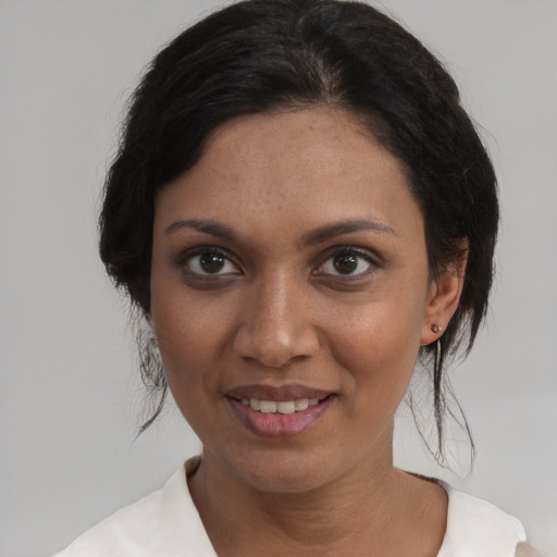 Joyful white young-adult female with medium  black hair and brown eyes