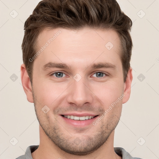 Joyful white young-adult male with short  brown hair and grey eyes